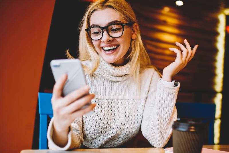 Woman on mobile phone happy with discount