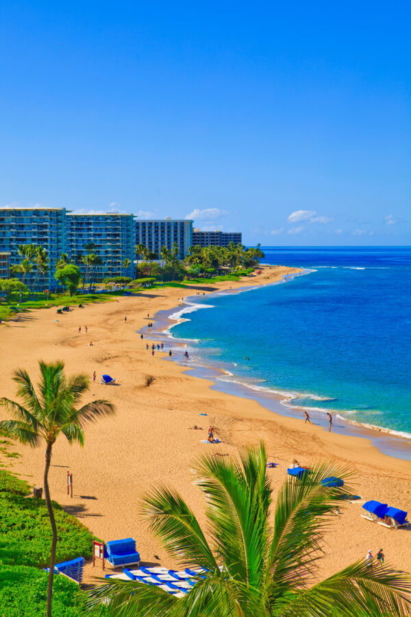 Stunning Kaanapali Beach in Maui with golden sand, blue water, and tropical resort views.