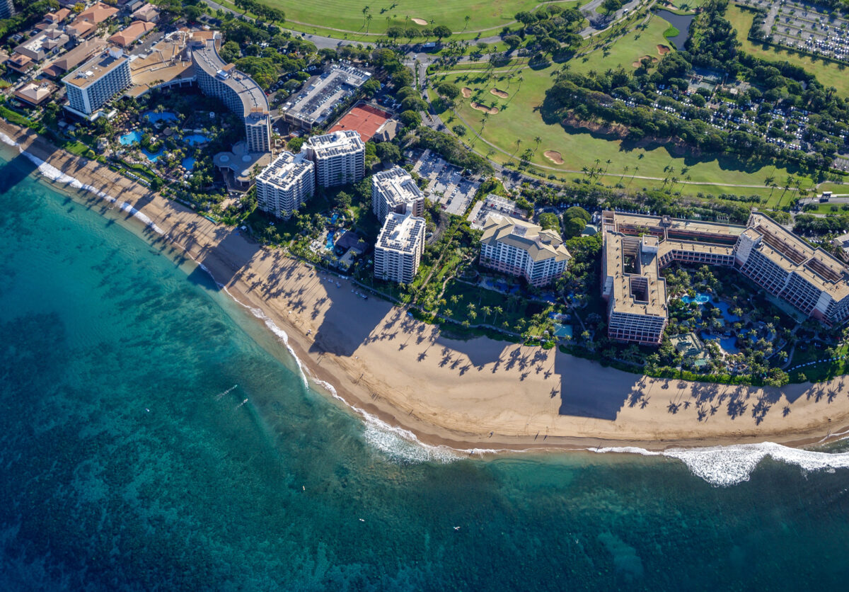 Aerial view of Kaanapali showcasing beaches, luxury resorts, and lush golf courses along the coastline.
