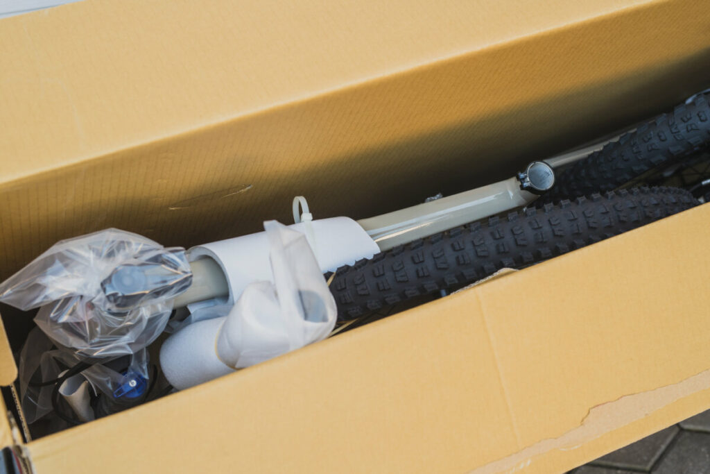 Close-up of a mountain bike packed in a cardboard box