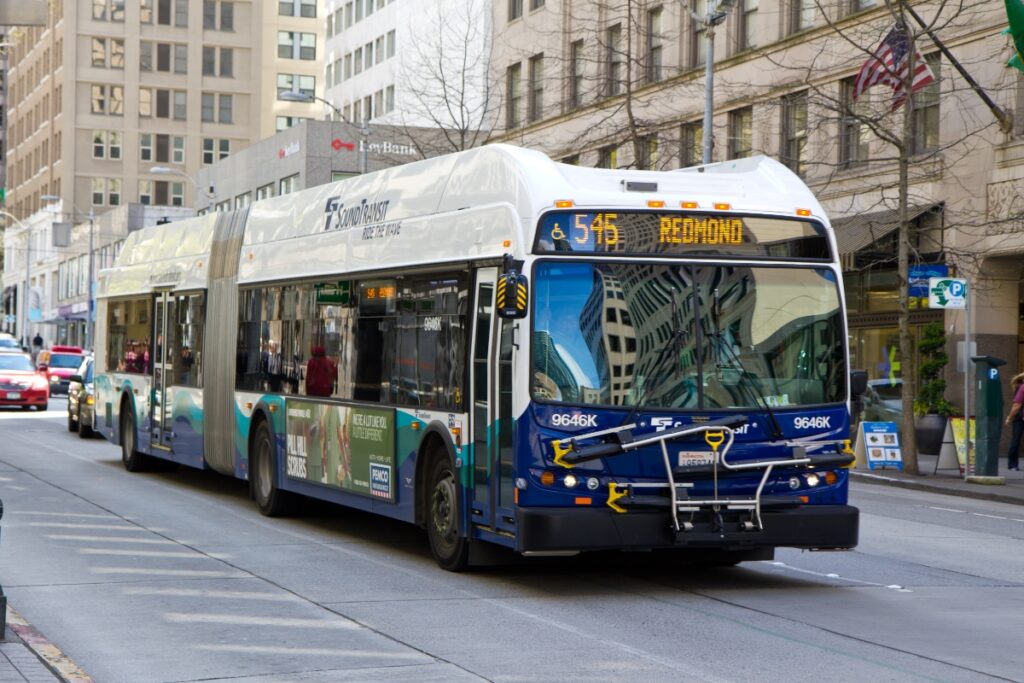 Articulated Sound Transit bus 545 on a busy urban street heading to Redmond.