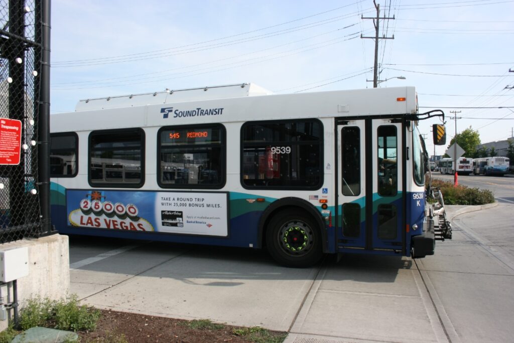 SoundTransit bus 545 in Redmond with Las Vegas travel ad and promotional offer.